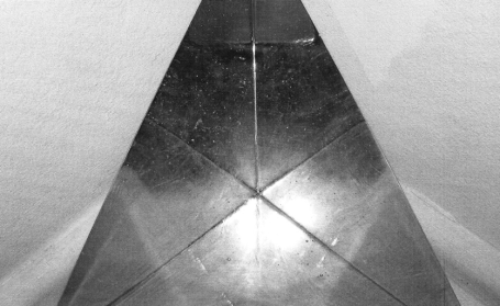 Silberne Pyramide mit reflektierender Oberfläche, perspektivisch von oben betrachtet.